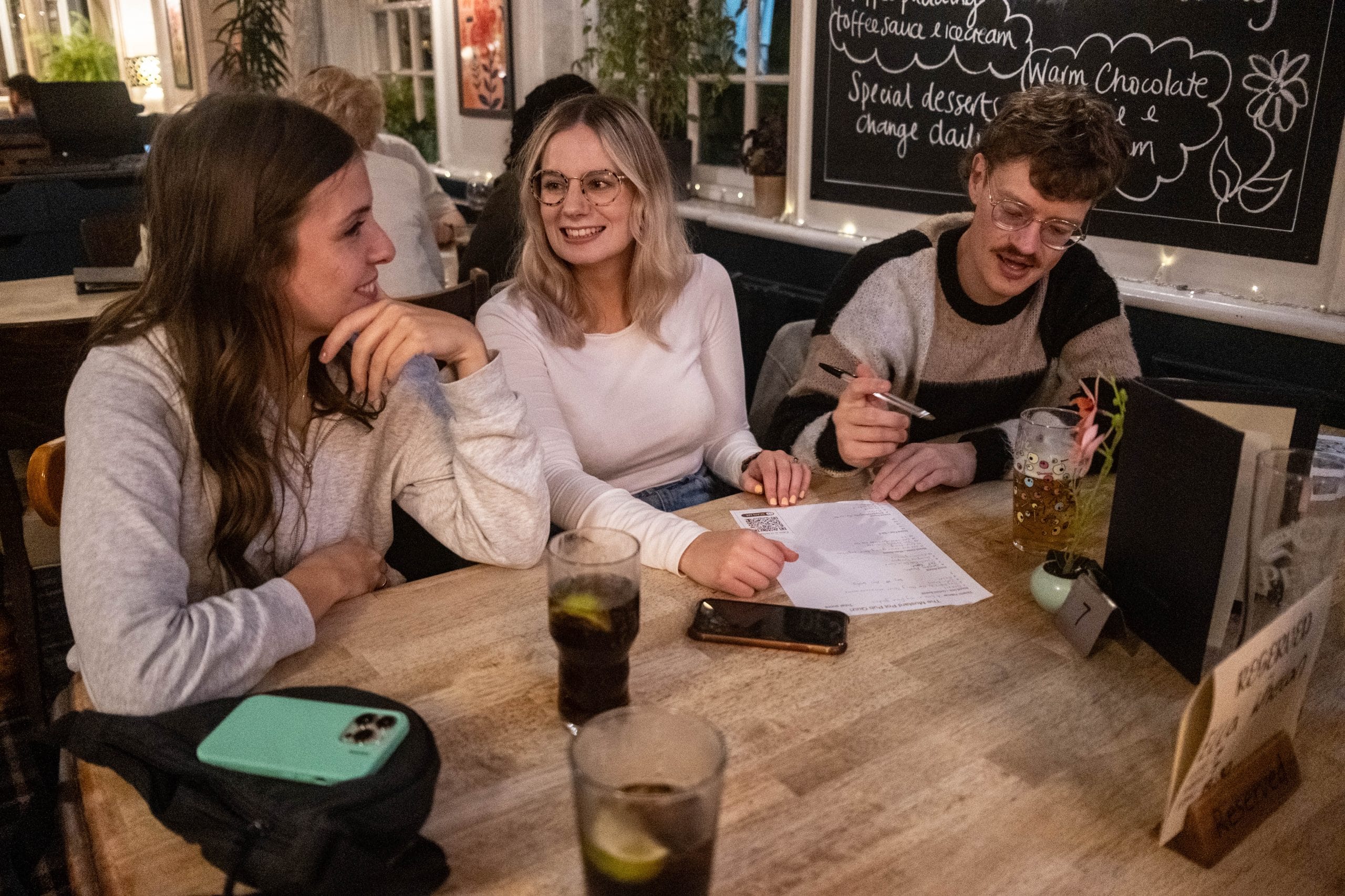 Three players looking at a quiz sheet
